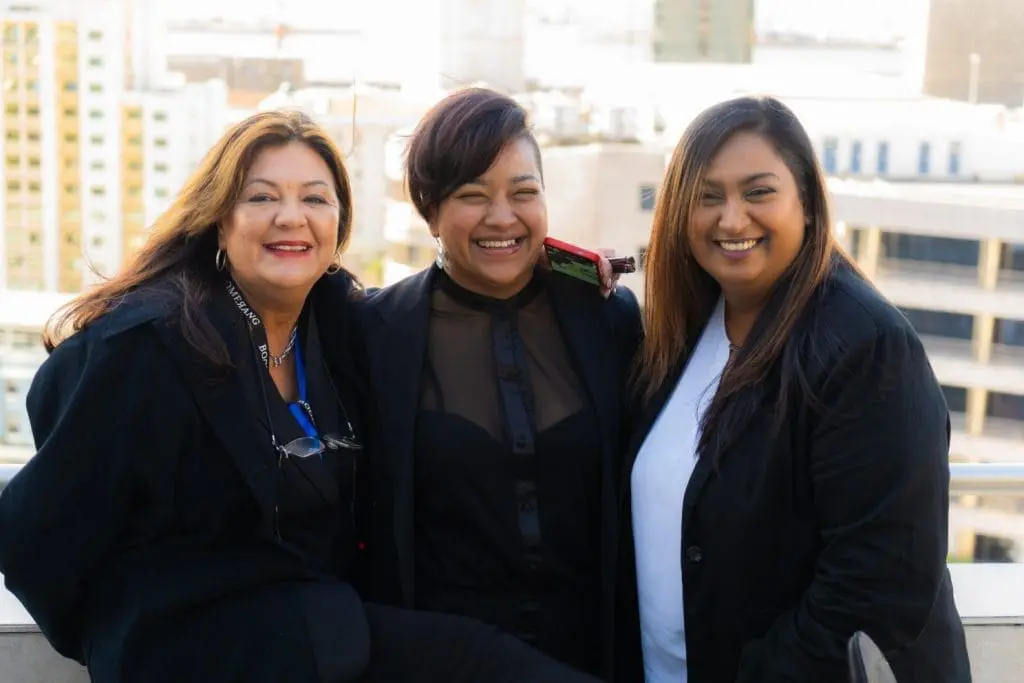 three ladies of Boomerang Management team smiling in photo. Left to right, Jacqueline, Dorianne & Natasha.