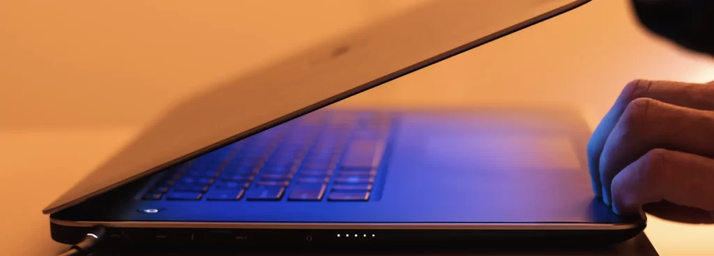 opening laptop for news updates and insights on screen
