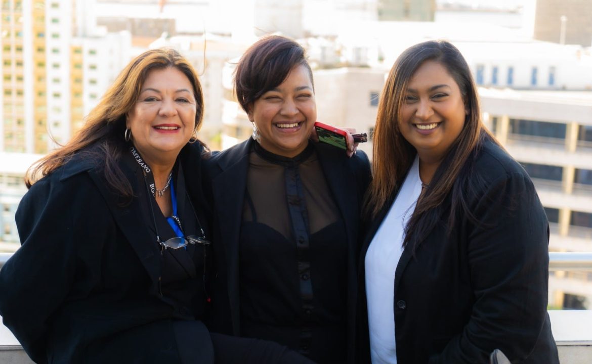 three ladies of Boomerang Management team smiling in photo. Left to right, Jacqueline, Dorianne & Natasha.